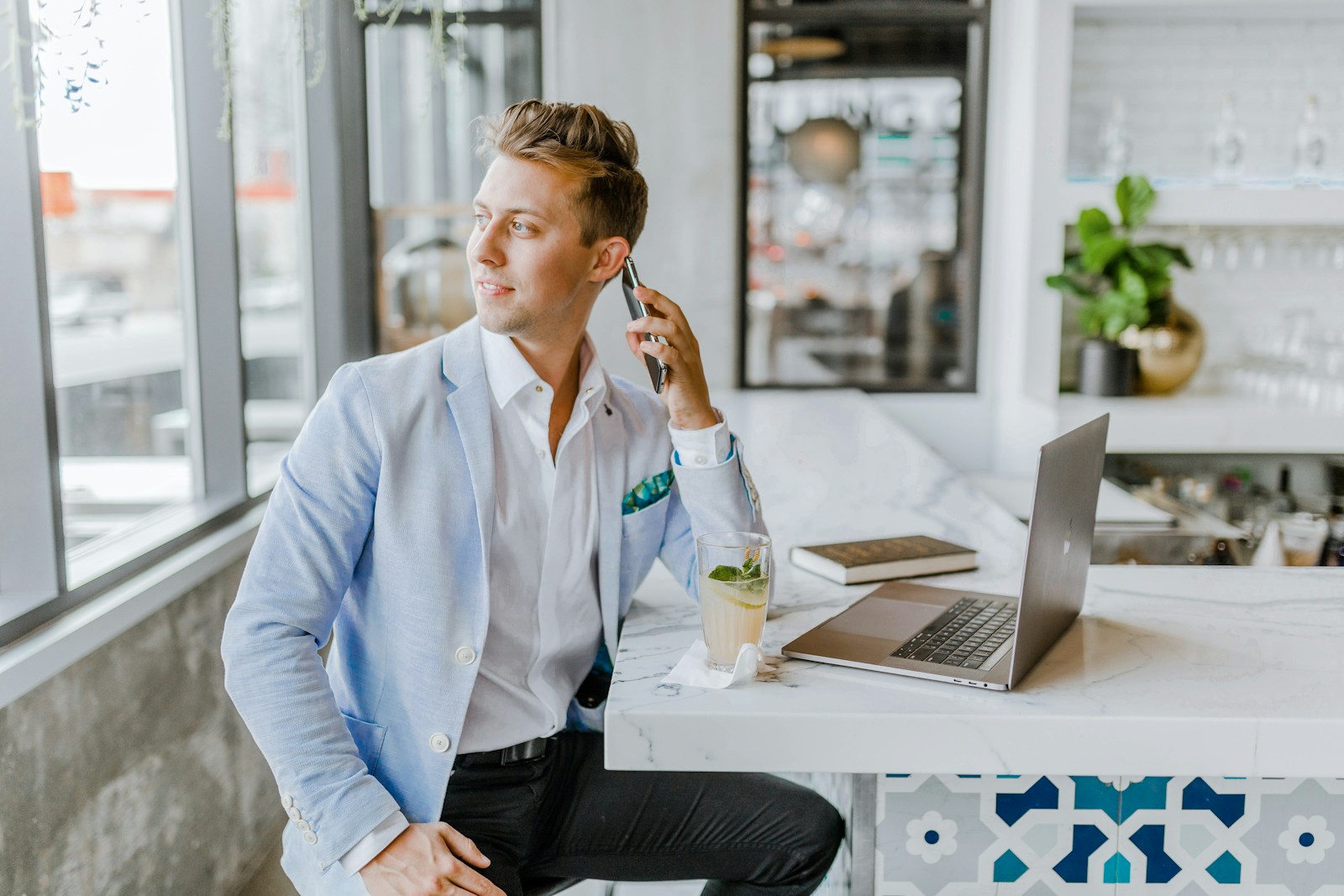 independent insurance agent sitting beside white wooden table